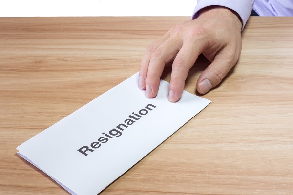 Hand of a businessman hands over a resignation letter Handing Over Resignation