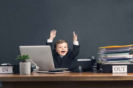 Humorous image of young boy working on a laptop computer Get It Done